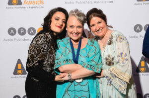 Three women posing together at the Audi awards after professional makeup application